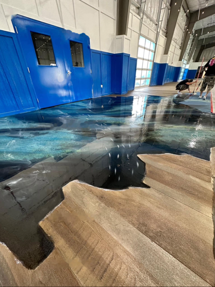 Blue and teal metallic epoxy floor with a high-gloss finish in a large interior