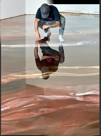 Copper and rose metallic epoxy floor being worked during installation