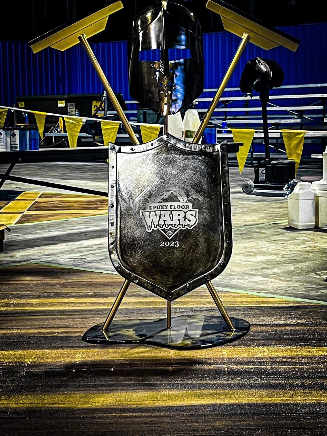 Epoxy Floor Wars 2023 shield trophy on display at the competition floor