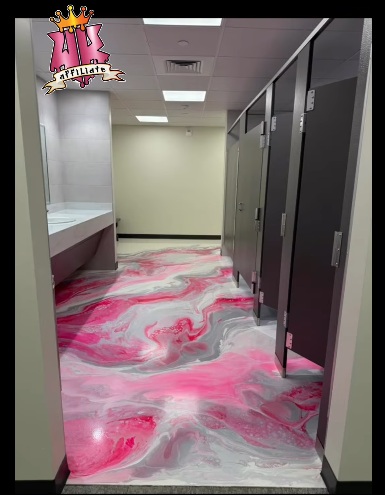 Pink and gray metallic epoxy floor in a commercial restroom